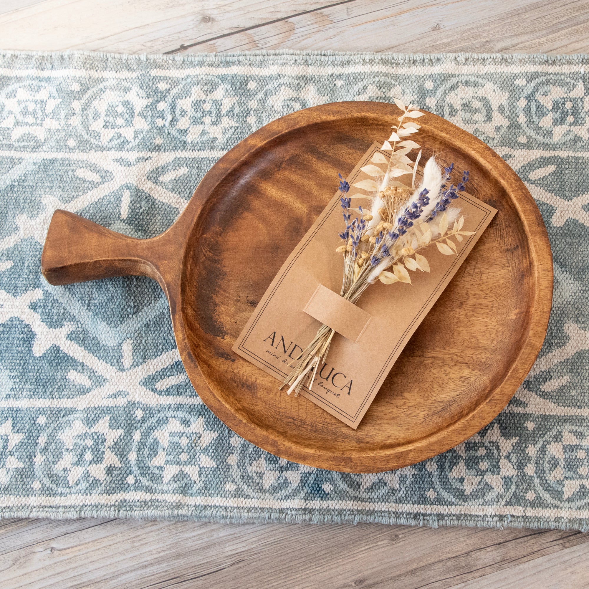 Round teak wood platter with one large handle.