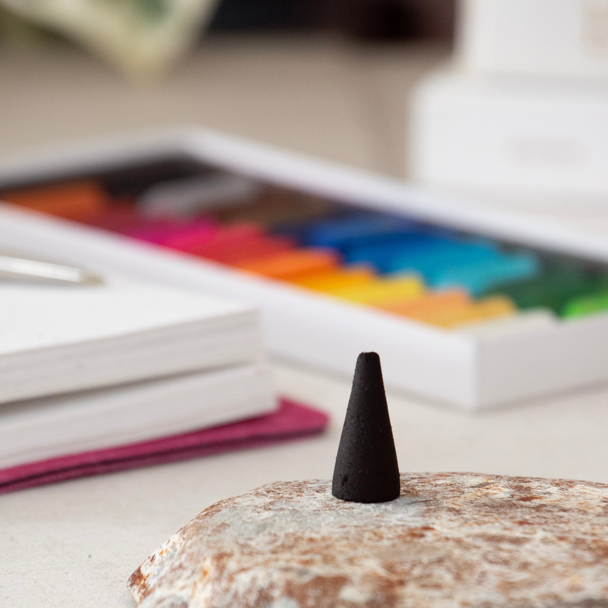 Black incense cone, in a lifestyle setting.