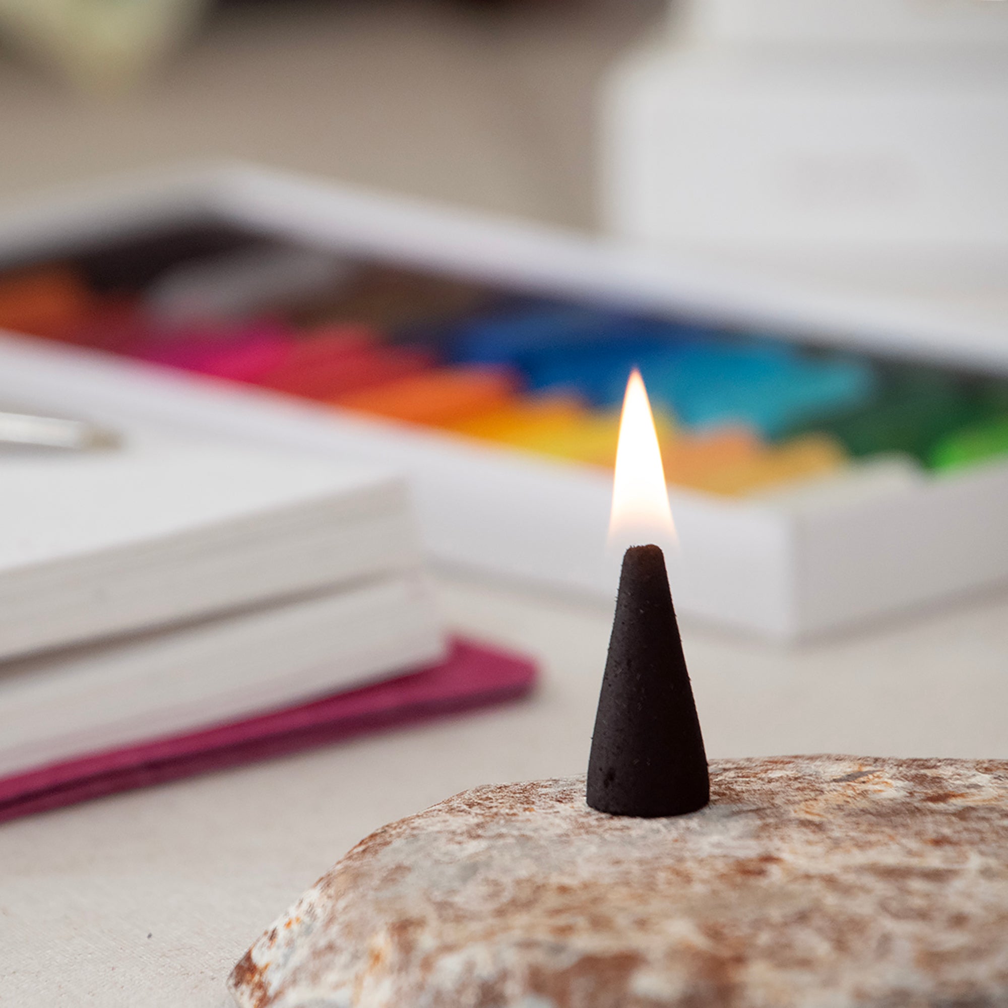 Lite black incense cone, in a lifestyle setting.
