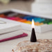 Lite black incense cone, in a lifestyle setting.