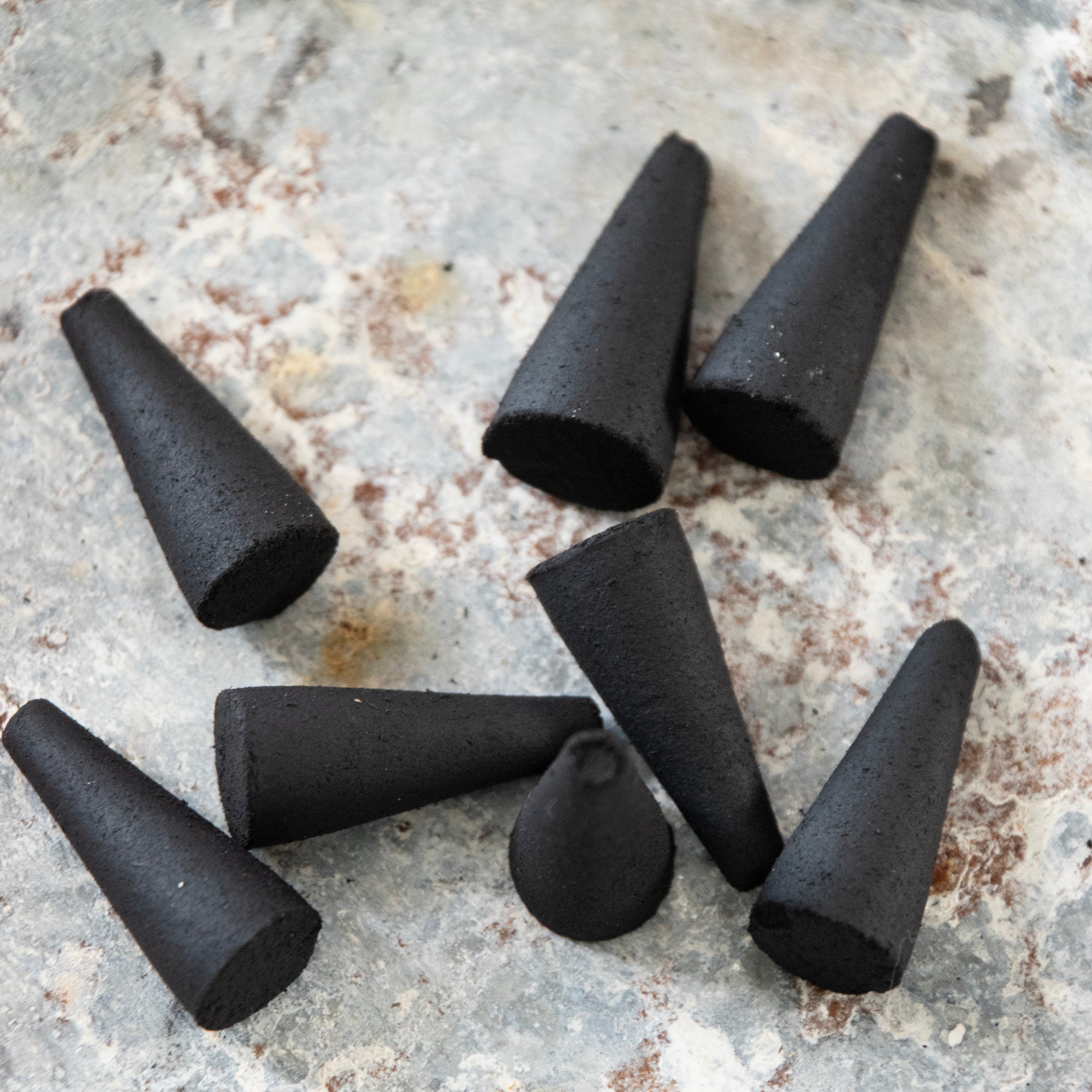 Pile of black incense cone, in a lifestyle setting.