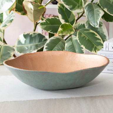 Large Round Turquoise Copper Cast Metal Decorative Bowl, in a room setting.