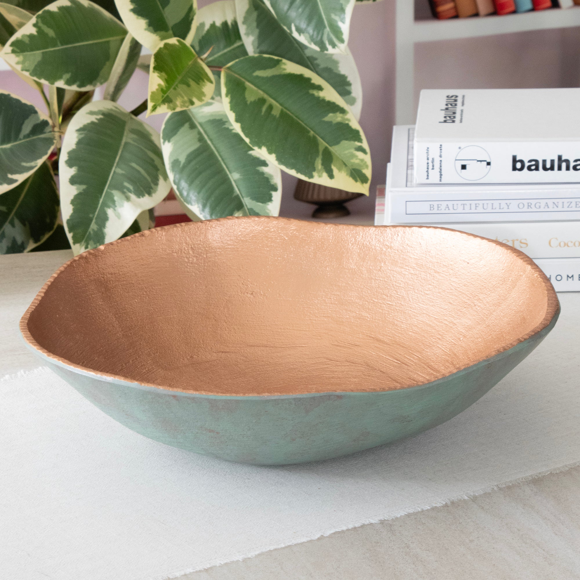 Empty Large Round Turquoise Copper Cast Metal Decorative Bowl, in a room setting.