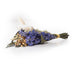 Mini bouquet with purple larkspur, willow eucalyptus, bunny tails, flax, and aveena laying down on a white background.