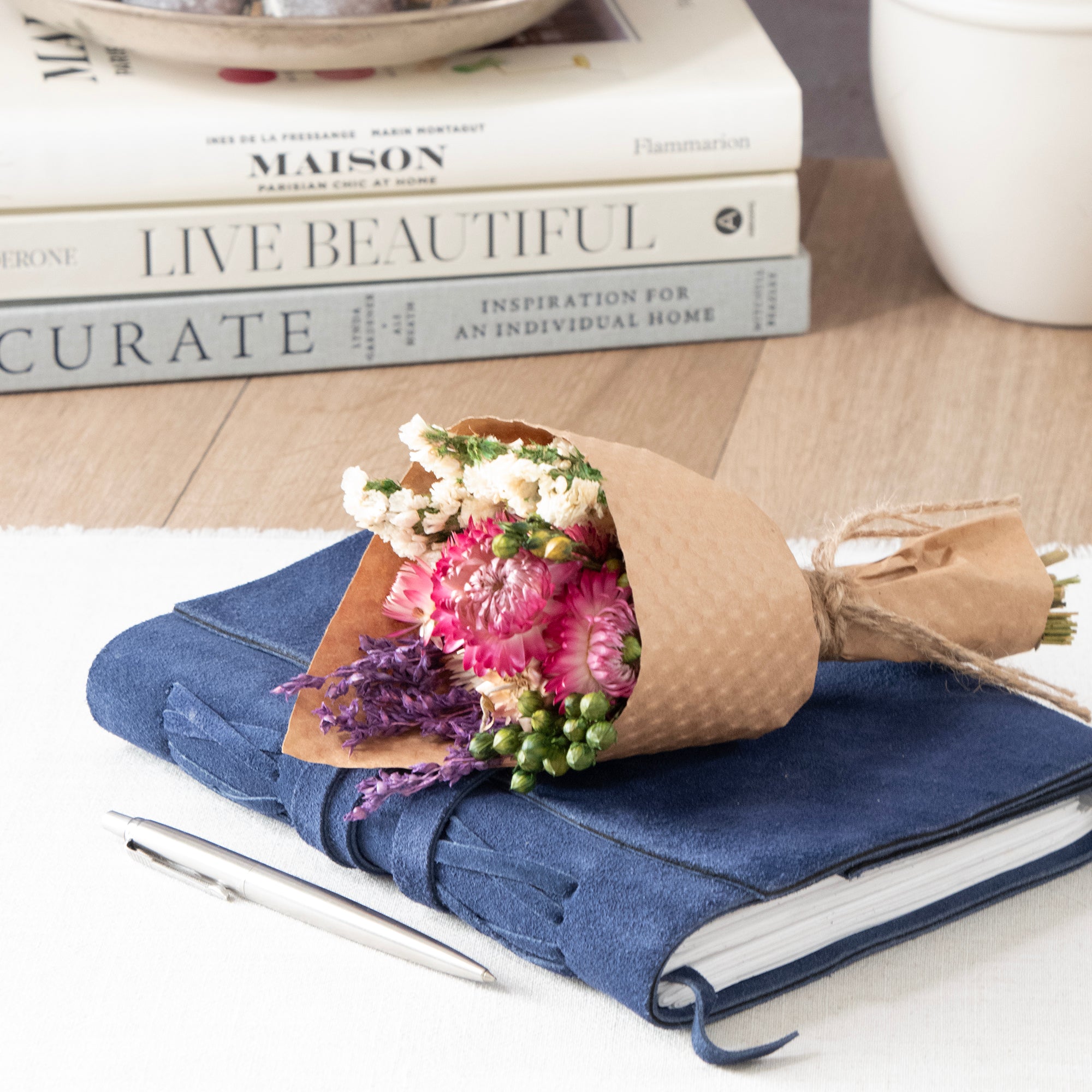 Mini Strawflower & Larkspur Bouquet Bundle, sitting on a large journal.