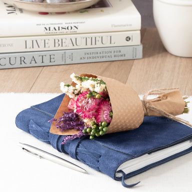 Mini Strawflower & Larkspur Bouquet Bundle, sitting on a large journal.