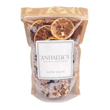 A clear resealable pouch of Andaluca California Hand Crafted Bath Salts, filled with coarse salt crystals and dried orange slices, on a white background.