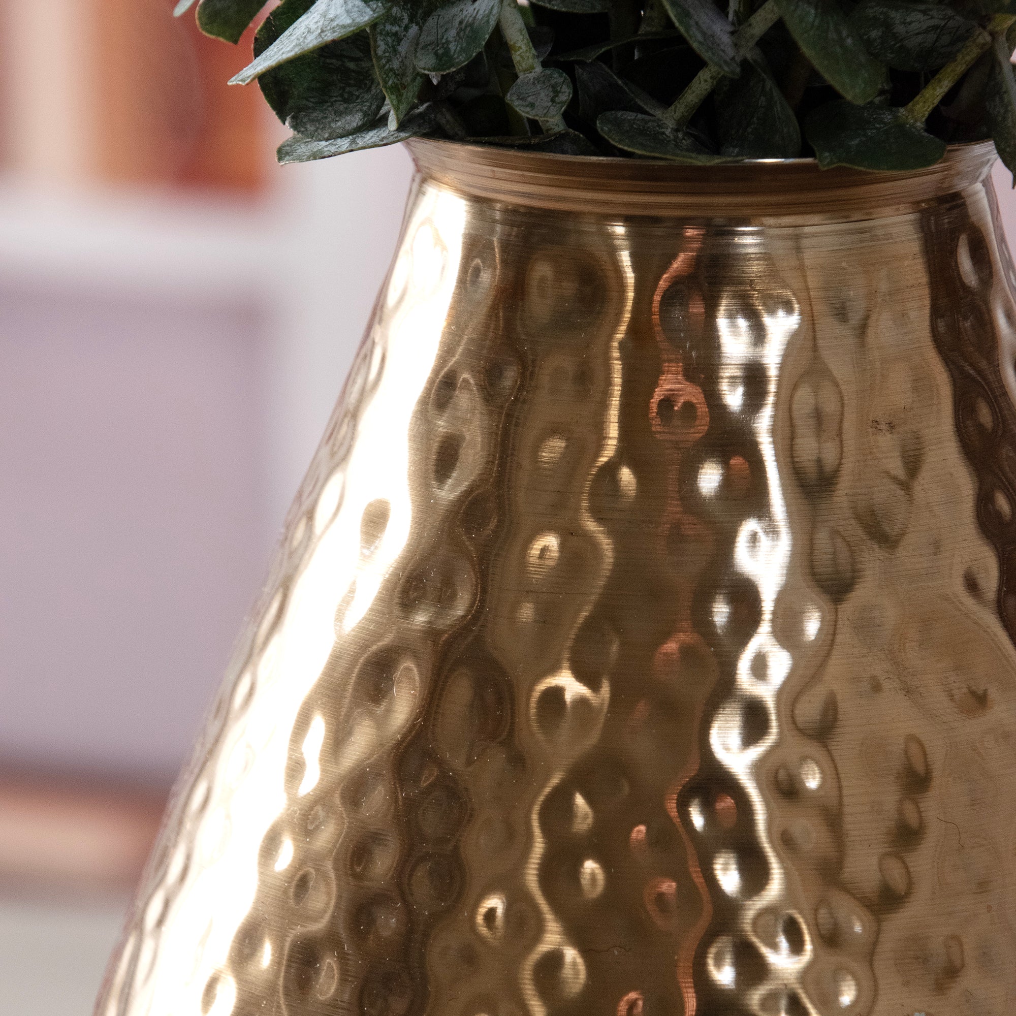 Close up of the Ombre Cast Metal Bronze Decorative Vase, in a room setting.