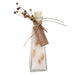 Glass bottle filled with bath salt and dried orange slices.