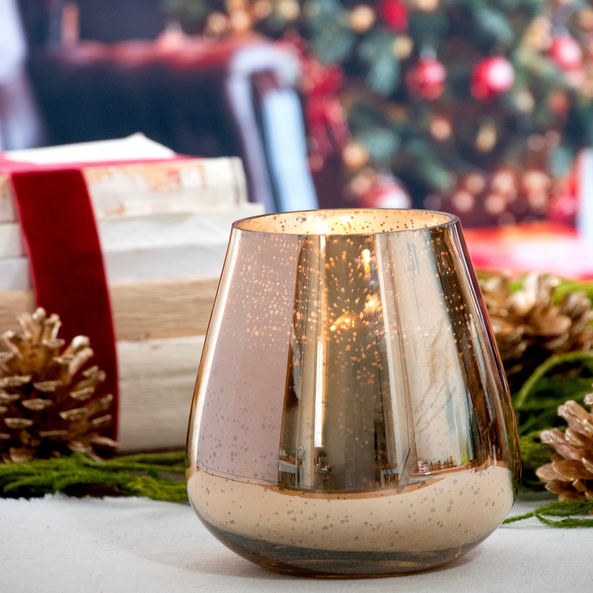 Golden mercury glass oval shape candle.