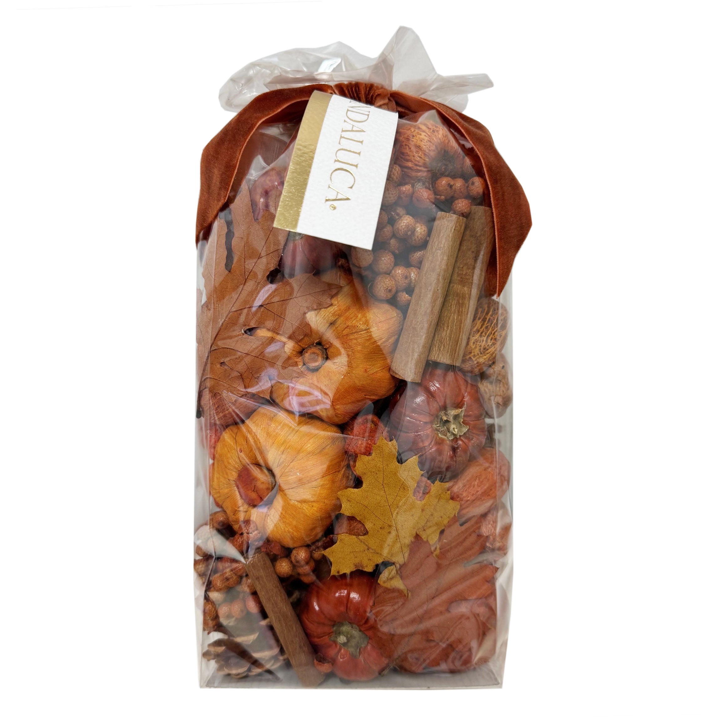 Packaged fall-themed potpourri with cinnamon sticks and autumn leaves on a white background