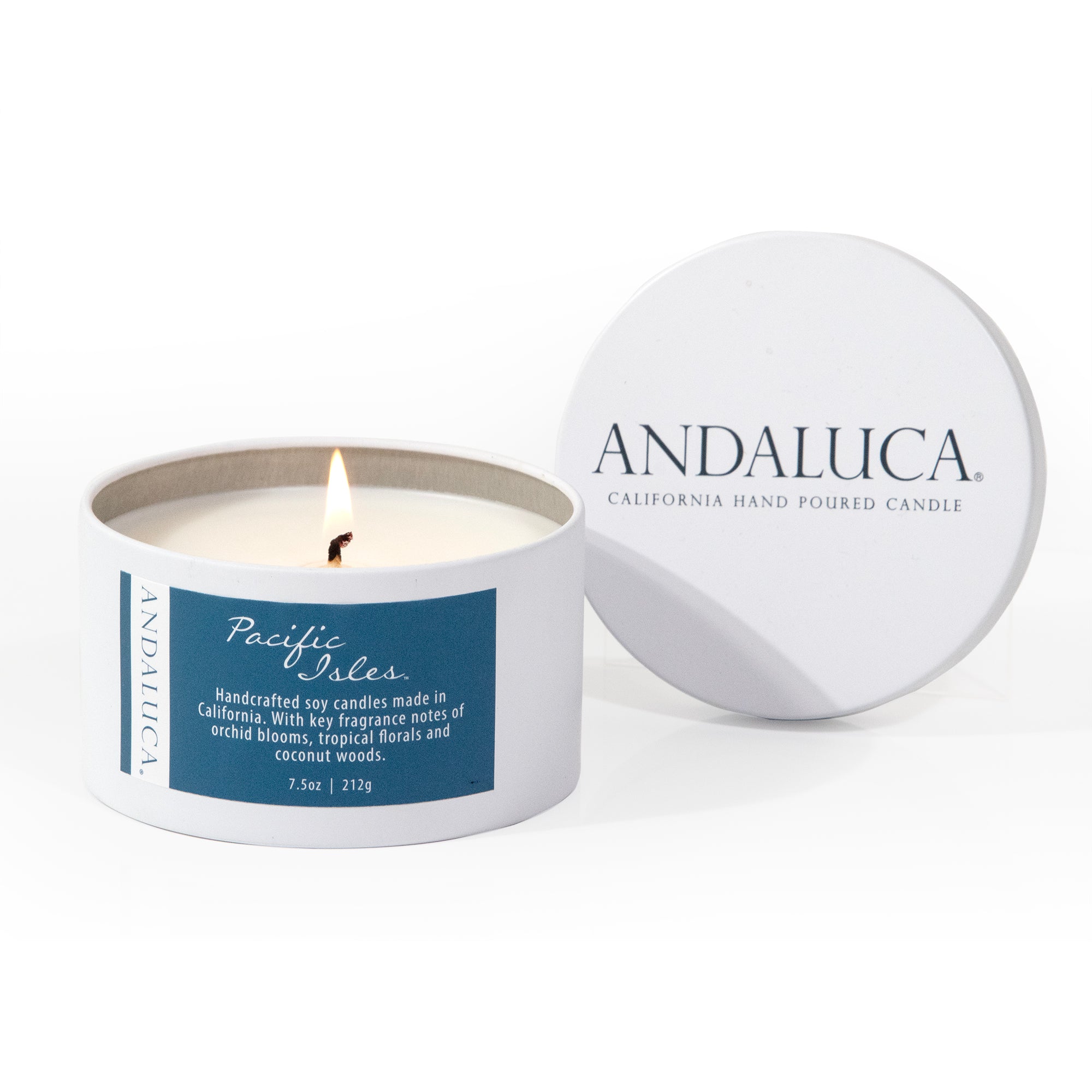 Pacific Isles tin candle product photo, candle burning, lid to the side.