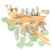 Contents of jar,  palo santo, eucalyptus and stones a pile.