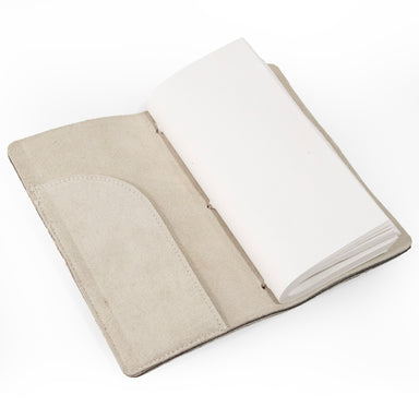 Beige suede journal open to first page.