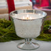 Silvery mercury glass pedestal with candle.