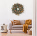 Decorative wreath with greenery, pinecones, and brown leaves in a room setting.