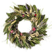 Prairie wreath made from dried flowers in pink, lavender, and white, and natural grains and green leaves.
