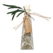 A clear glass bottle with a white stopper, filled with coarse white salt crystals and dried botanicals, tied with twine and a kraft paper tag reading ANDALUCA, with green leaves attached, on a white background.