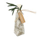 A clear glass bottle filled with dried white botanicals and tied with twine, featuring a kraft paper tag that reads 'ANDALUCA' and green leaves at the top, shown on a white background.