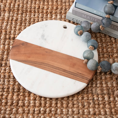 Cutting board made of white marble and wood.