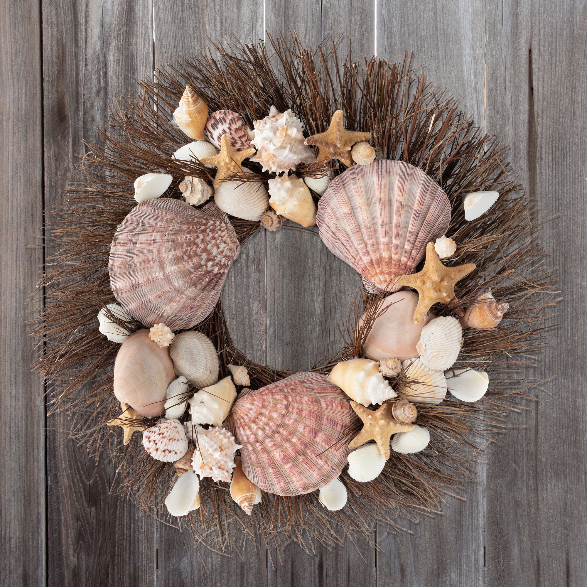 Wreath made from brown starfish, clamshells, and white conch shells on brown twig wreath base.