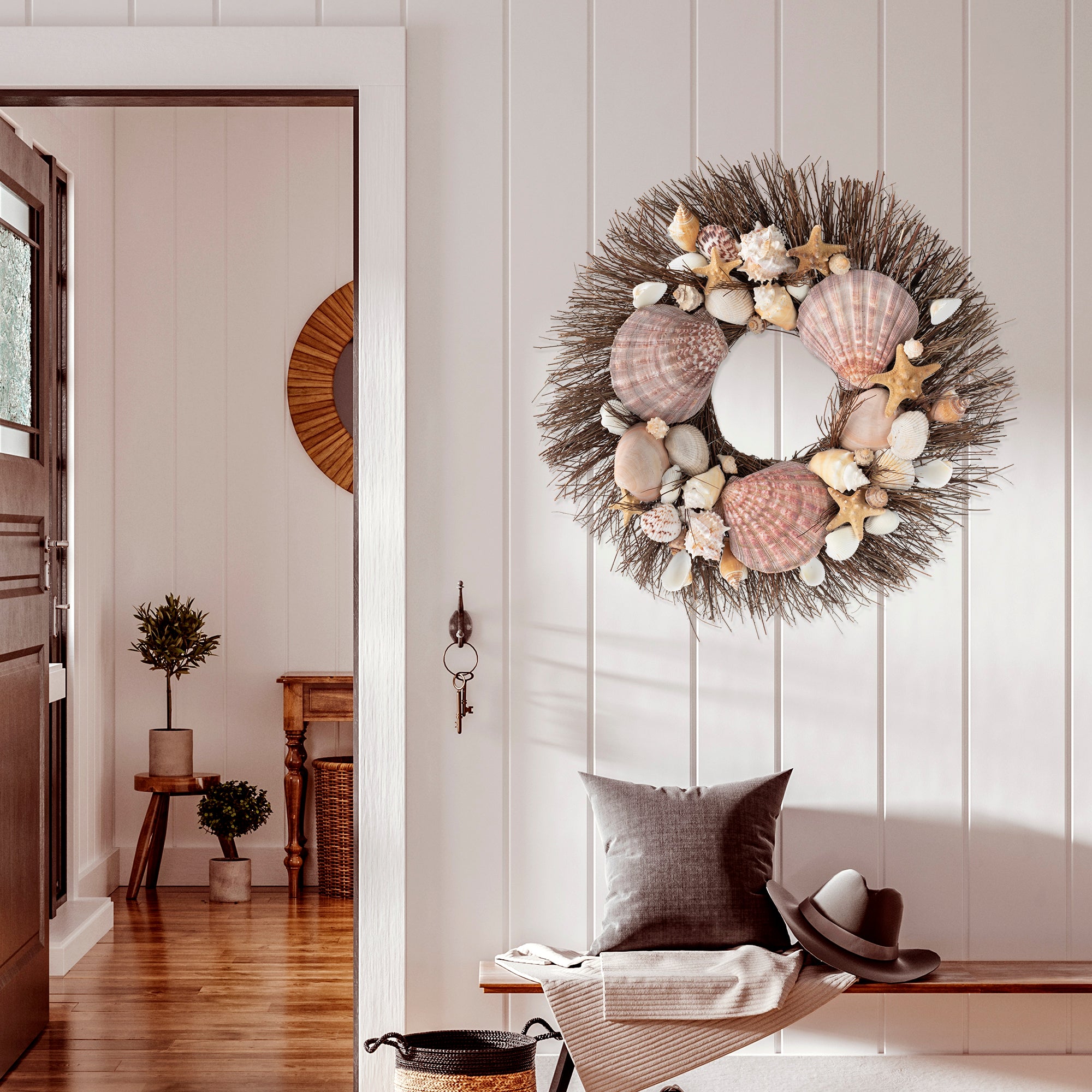 Wreath made from brown starfish, clamshells, and white conch shells on brown twig wreath base.