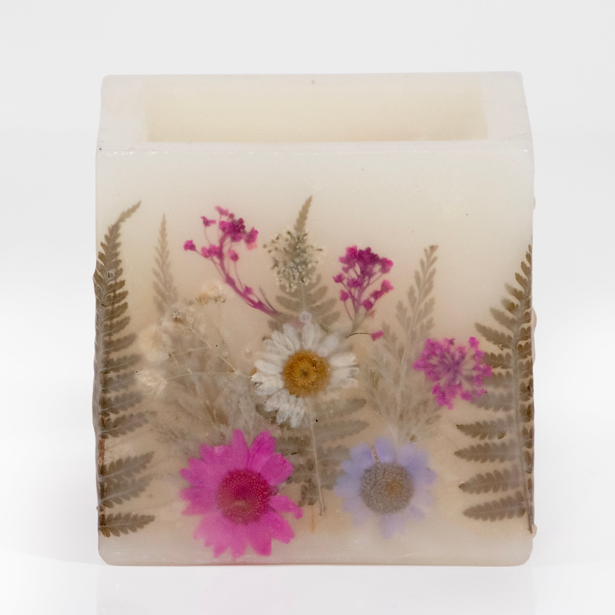 Pressed flower filled wax hurricane with pink flowers.