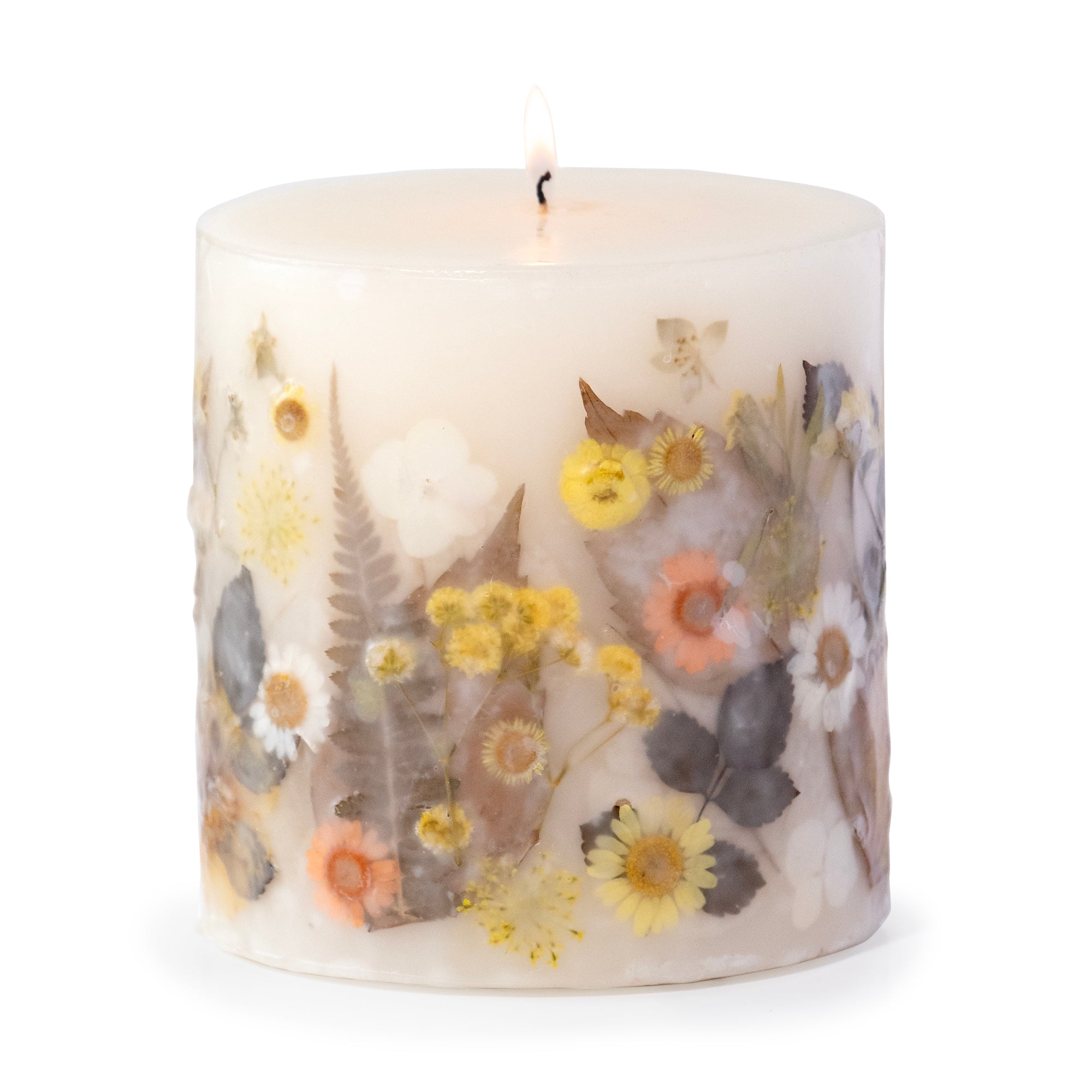 Ivory pillar candle with delicate pressed flowers in yellow and white along with green leaves decorating the outside of the candle.