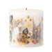 Ivory pillar candle with delicate pressed flowers in yellow and white along with green leaves decorating the outside of the candle.