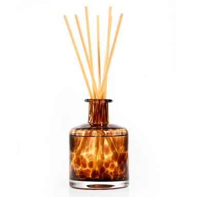 Tortoise pattern glass reed diffuser in brown color.