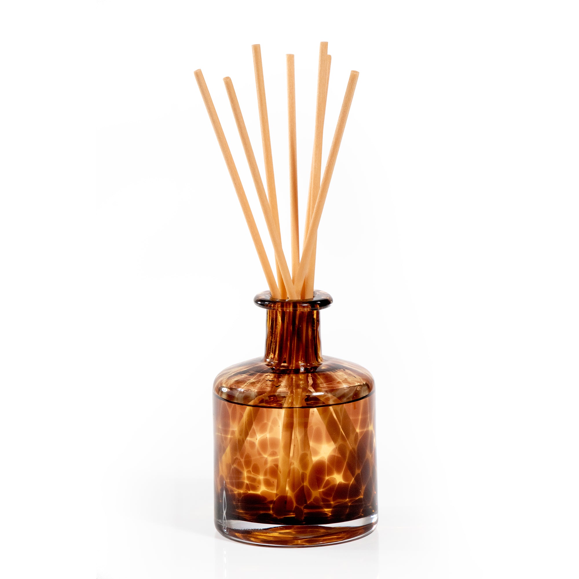 Tortoise pattern glass reed diffuser in brown color.