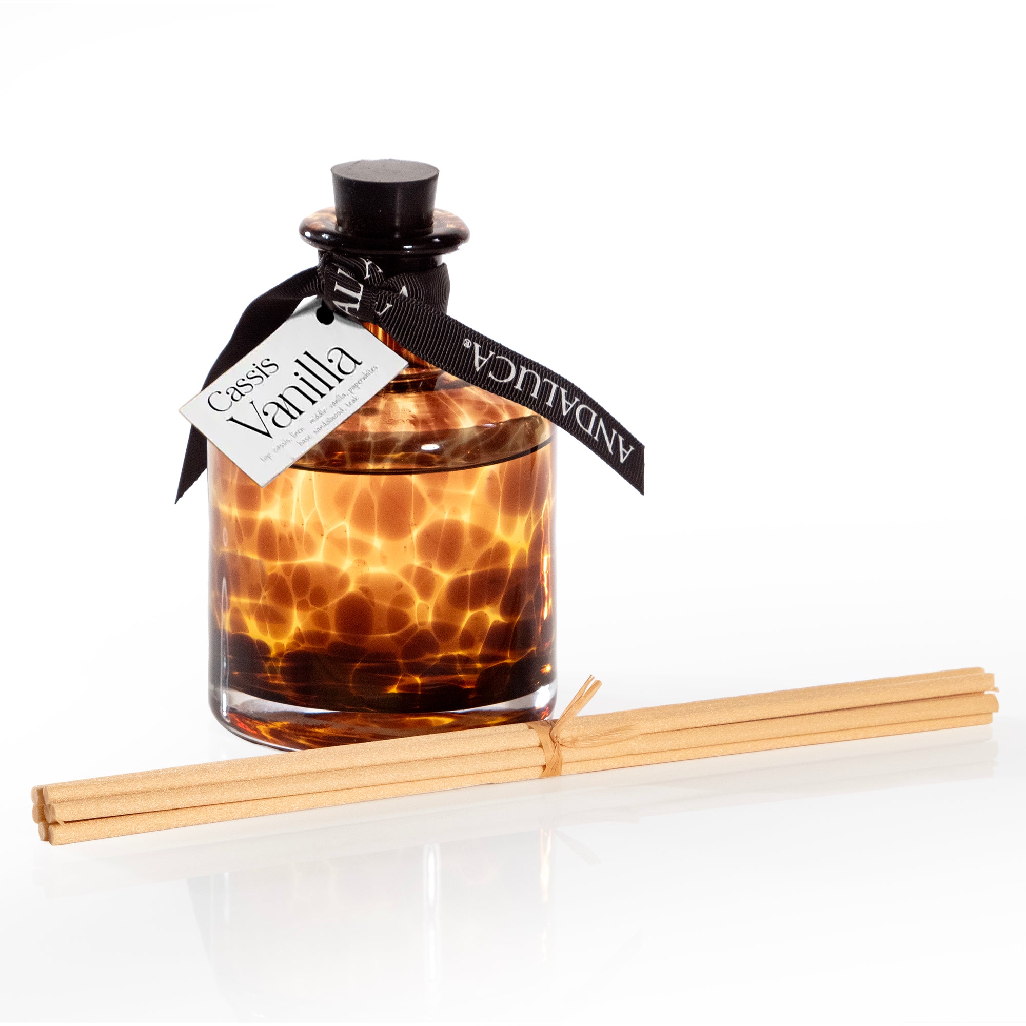 Tortoise pattern glass reed diffuser in brown color.