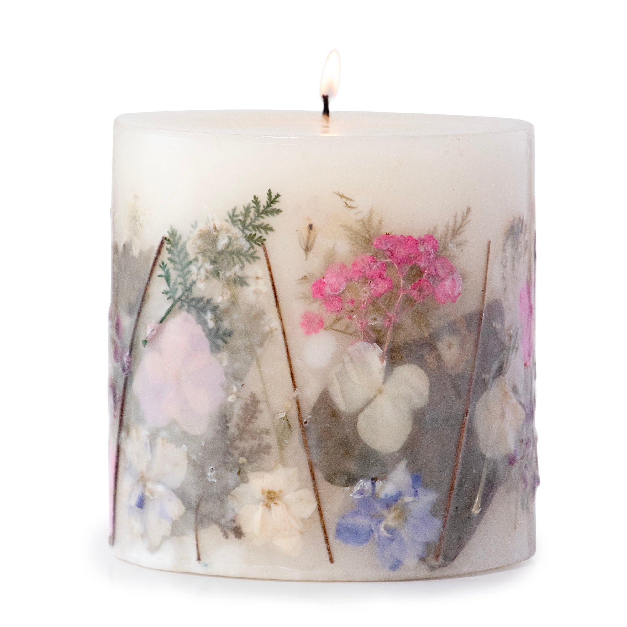 Ivory pillar candle with delicate pressed pink and purple flowers and green leaves decorating the outside of the candle.