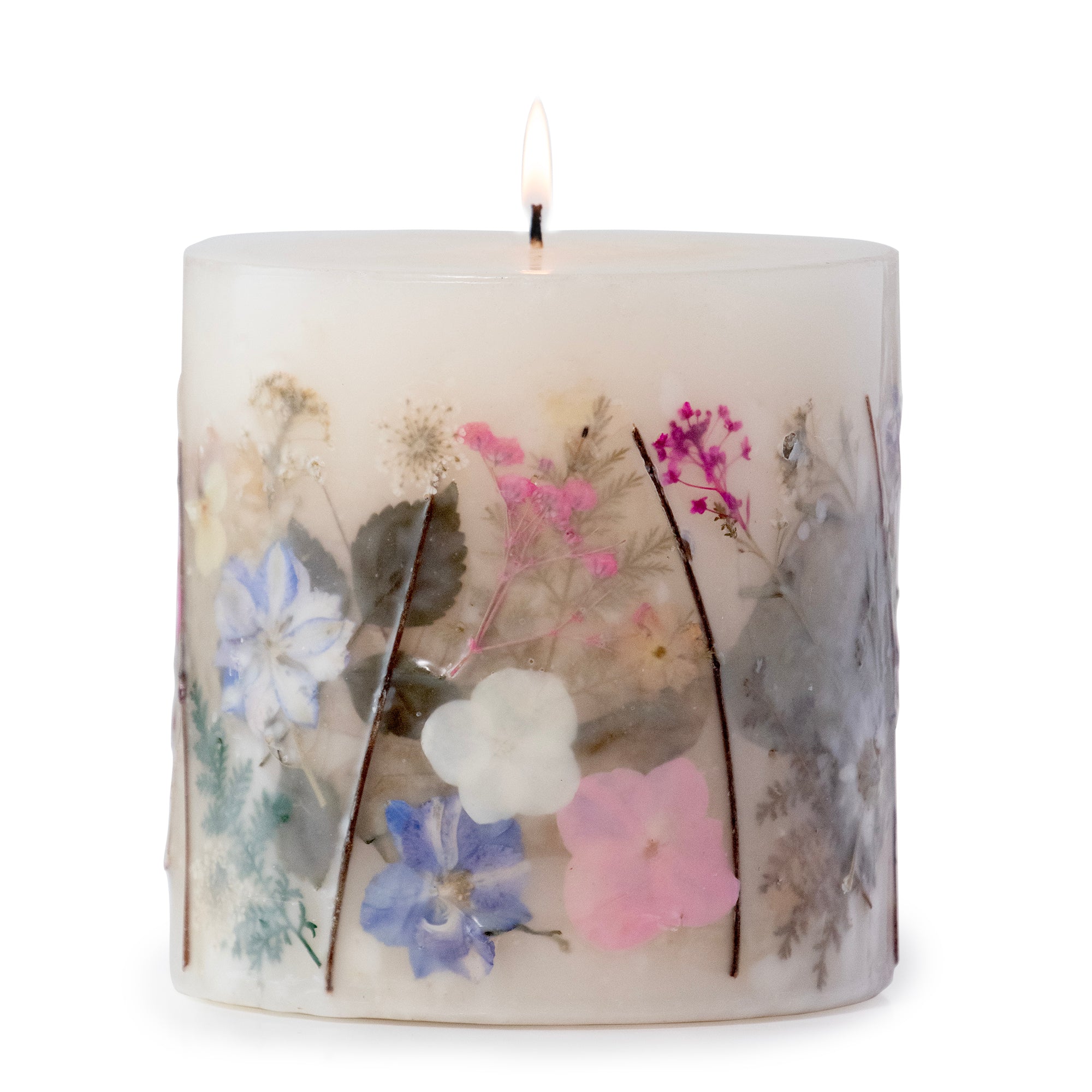 Ivory pillar candle with delicate pressed pink and purple flowers and green leaves decorating the outside of the candle.