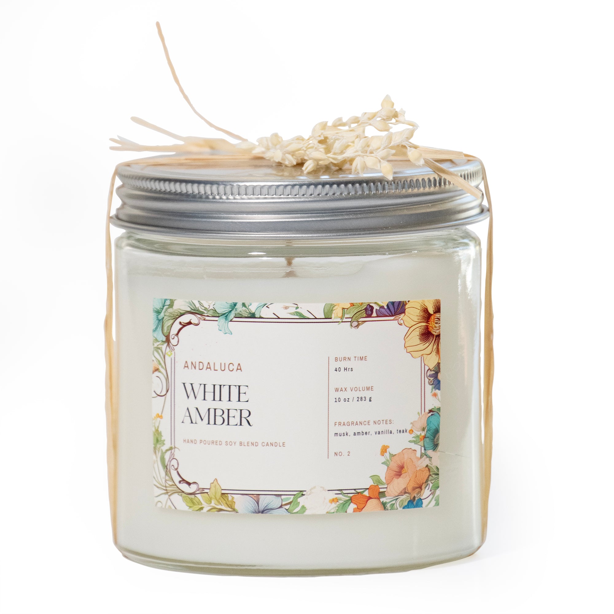 Clear glass filled with white wax candle  with colorful floral label.