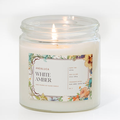 Clear glass filled with white wax candle  with colorful floral label.