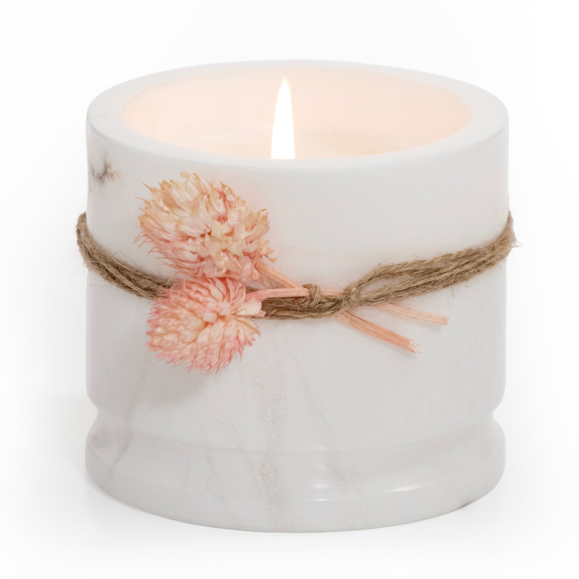 Lit white marble candle cup with flower tie. Product shot, on white background.