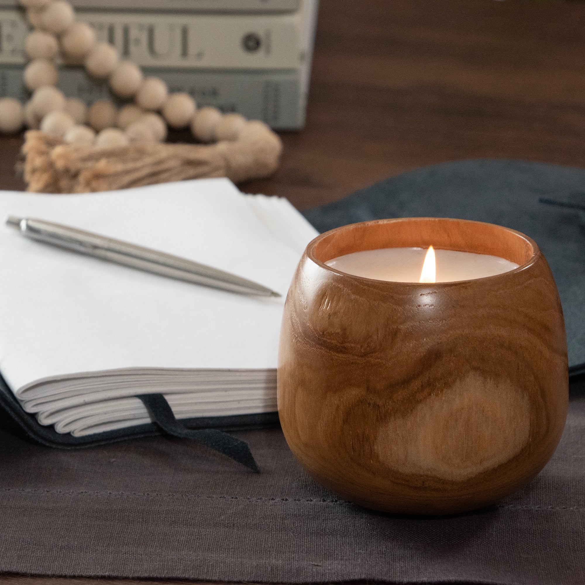 Candle filled into wood cup.