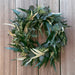 Willow and Silver Dollar Eucalyptus Wreath on wood background